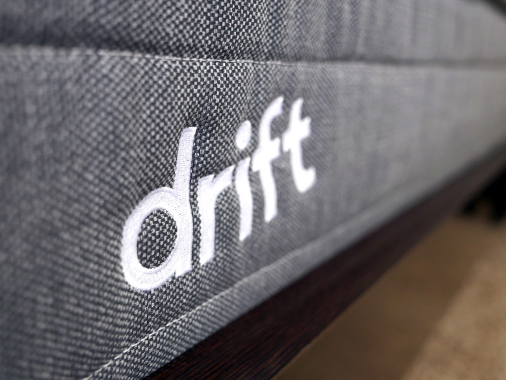 Ultra close up shot of the Drift mattress logo