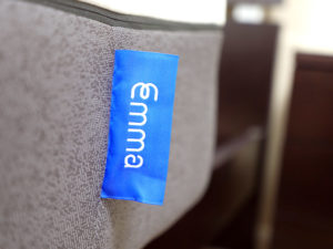 Ultra close up shot of the Emma mattress logo